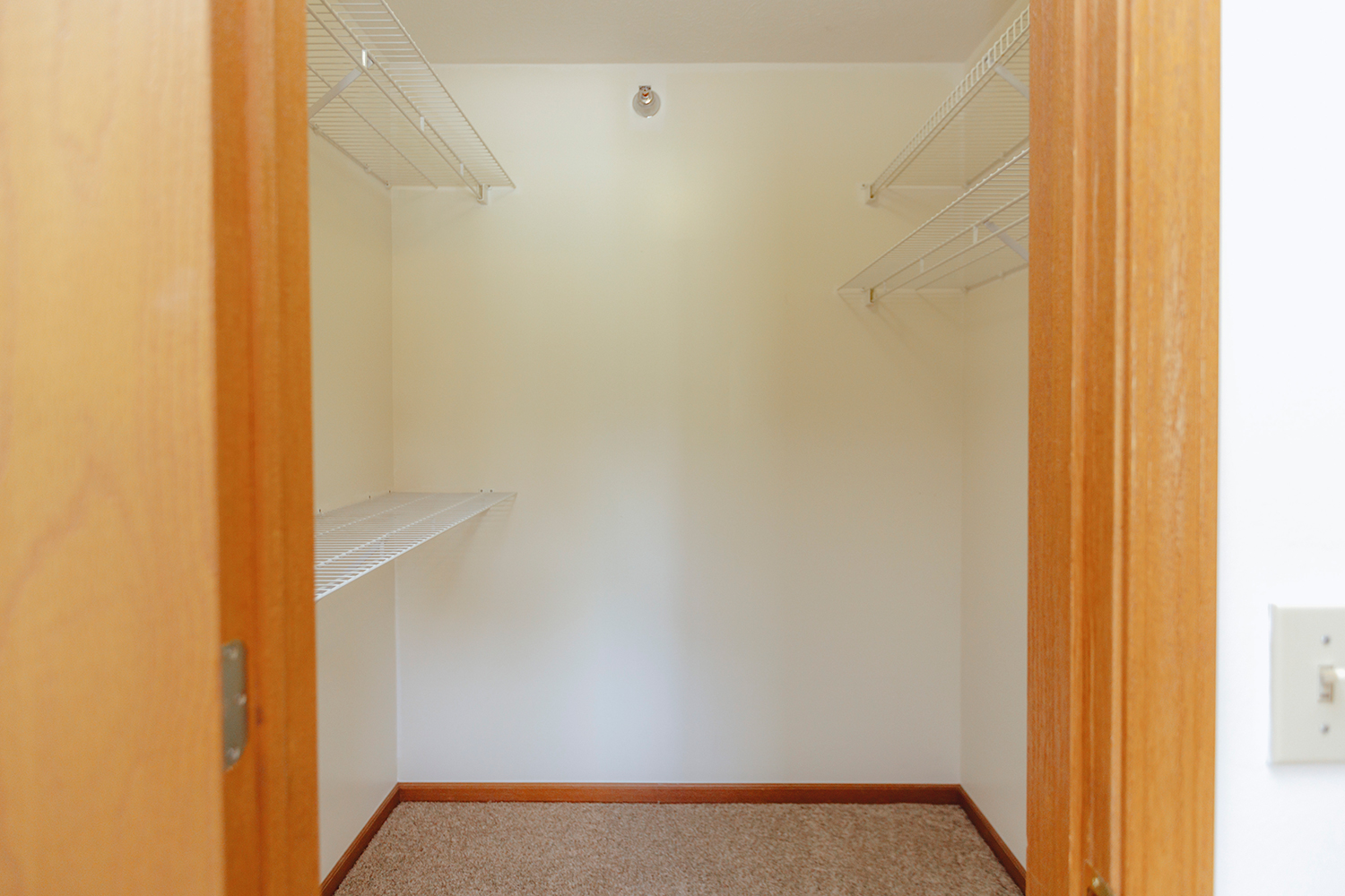 Walk-in closet interior of Sunset Floorplan: 1 bedroom with den